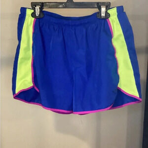 Champion blue running shorts with yellow sides and purple seams.